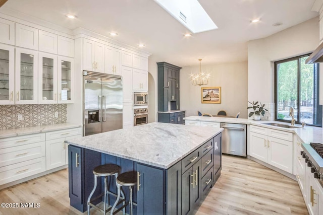 3605 N Langdale Trl, Flagstaff, AZ 86001 - kitchen featuring built in appliances, a sink, a chandelier, white cabinetry, and recessed lighting