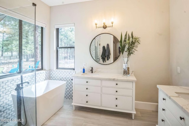 3605 N Langdale Trl, Flagstaff, AZ 86001 - full bathroom with two vanities, a freestanding bath, tile walls, and a wainscoted wall