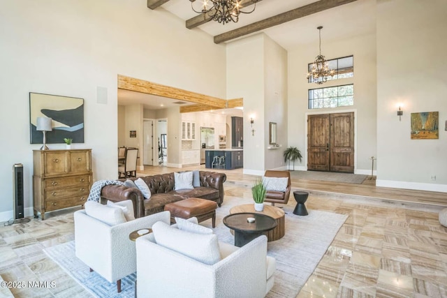 3605 N Langdale Trl, Flagstaff, AZ 86001 - living area featuring a chandelier, a towering ceiling, baseboards, and beamed ceiling