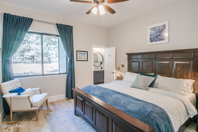 3605 N Langdale Trl, Flagstaff, AZ 86001 - bedroom featuring light wood-style flooring, baseboards, a ceiling fan, and connected bathroom