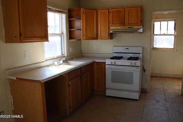 kitchen featuring white gas range and sink