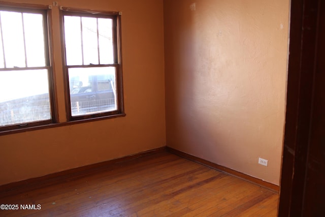 unfurnished room featuring hardwood / wood-style flooring