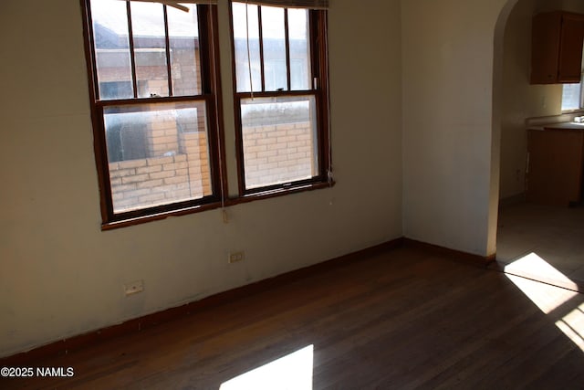 empty room featuring dark hardwood / wood-style flooring and a mountain view