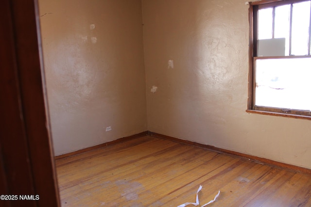 spare room featuring a wealth of natural light and light wood-type flooring