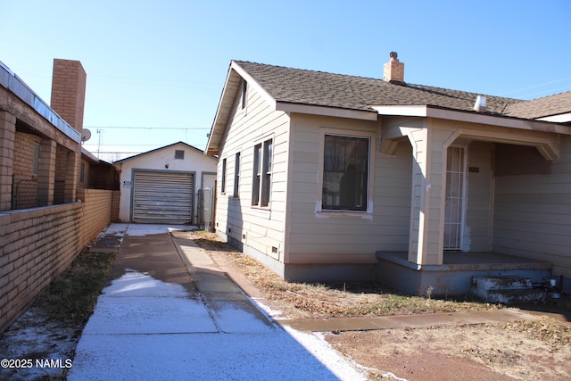 view of side of property with an outbuilding and a garage