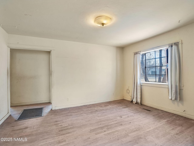 spare room featuring light hardwood / wood-style floors