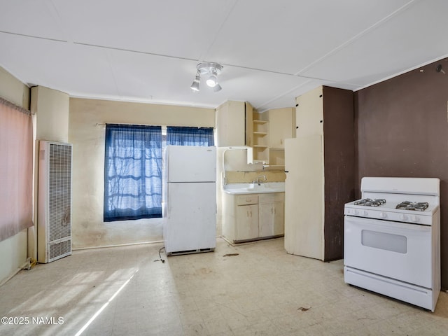 kitchen featuring white appliances and sink