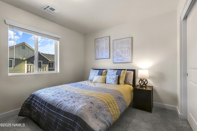 carpeted bedroom featuring visible vents and baseboards