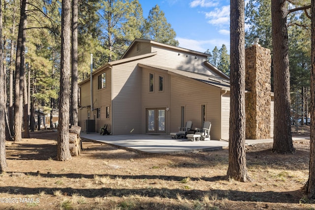 1420 N Royal Oaks Way, Flagstaff, AZ 86004 - rear view of house featuring french doors, a patio area, and central AC unit