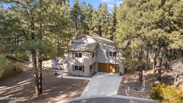 1420 N Royal Oaks Way, Flagstaff, AZ 86004 - view of front of home with concrete driveway, an attached garage, and roof with shingles