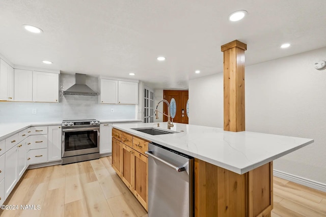 1420 N Royal Oaks Way, Flagstaff, AZ 86004 - kitchen featuring appliances with stainless steel finishes, wall chimney range hood, a sink, light wood finished floors, and recessed lighting
