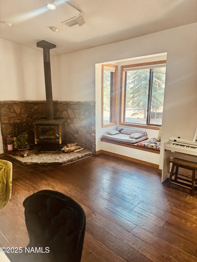 5070 N Weatherford Rd, Flagstaff, AZ 86001 - living area featuring a wood stove and hardwood / wood-style flooring