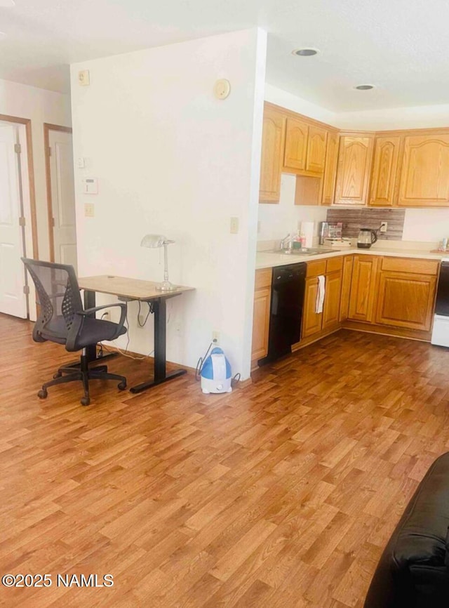 5070 N Weatherford Rd, Flagstaff, AZ 86001 - kitchen with light countertops, light wood-type flooring, and black dishwasher