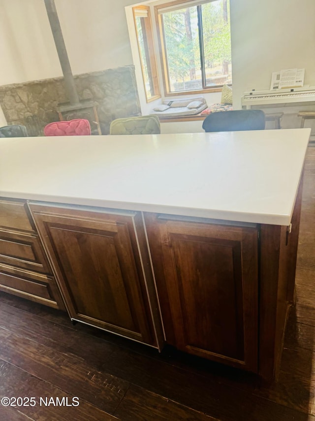 5070 N Weatherford Rd, Flagstaff, AZ 86001 - kitchen with dark wood finished floors, a wood stove, and light countertops