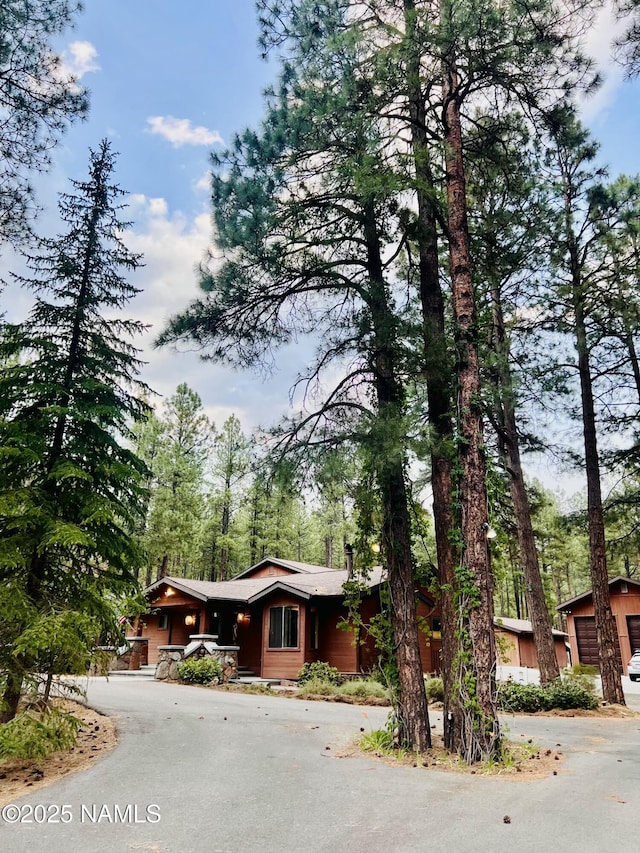 5070 N Weatherford Rd, Flagstaff, AZ 86001 - view of front of property with curved driveway and a garage