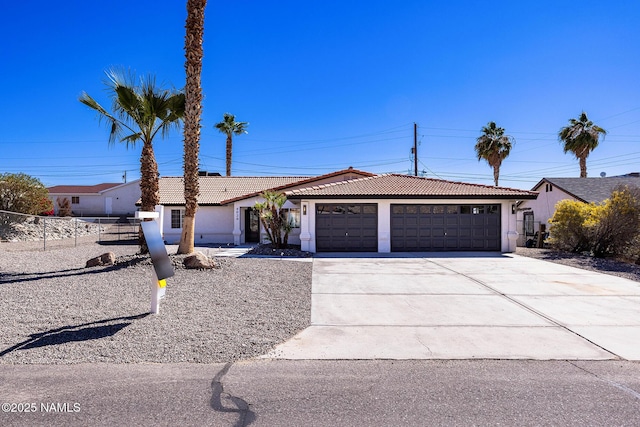 ranch-style home featuring an attached garage, driveway, a tile roof, and stucco siding