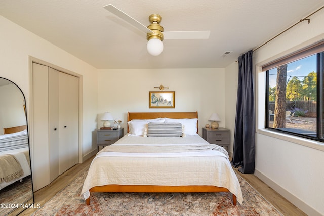 bedroom with a closet, ceiling fan, and hardwood / wood-style floors