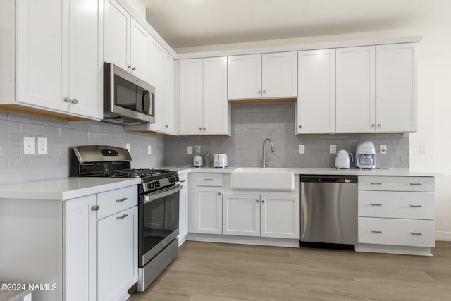 kitchen featuring sink, white cabinets, and stainless steel appliances