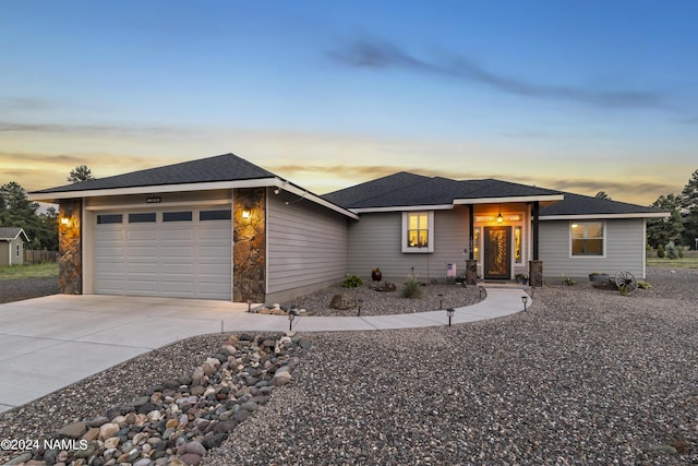 prairie-style home featuring concrete driveway and an attached garage