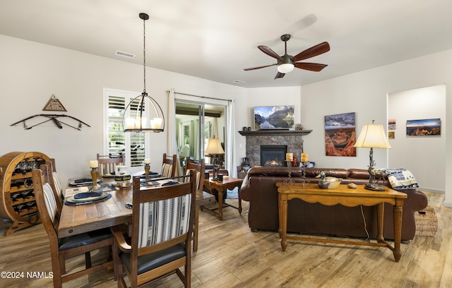 dining space featuring visible vents, a ceiling fan, and light wood-style floors