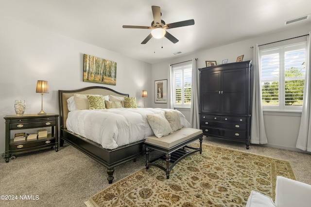 carpeted bedroom featuring visible vents, ceiling fan, and baseboards