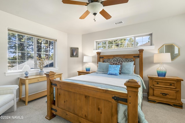 bedroom with ceiling fan and light carpet