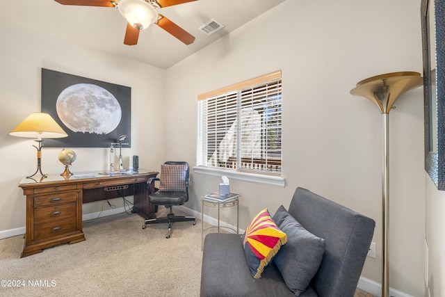 carpeted office space with ceiling fan