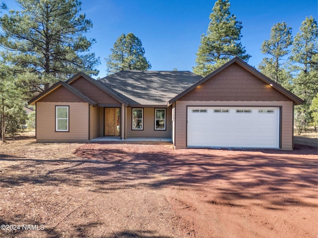 ranch-style home featuring a garage