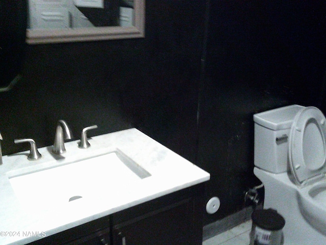 interior space with tile patterned floors, toilet, and vanity