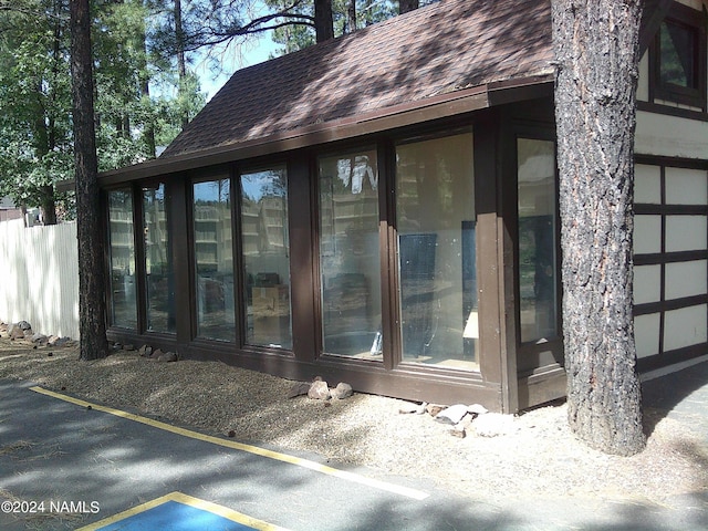 view of property exterior with a sunroom