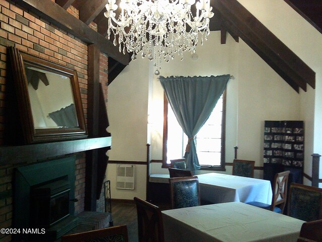 dining area featuring a chandelier and a fireplace