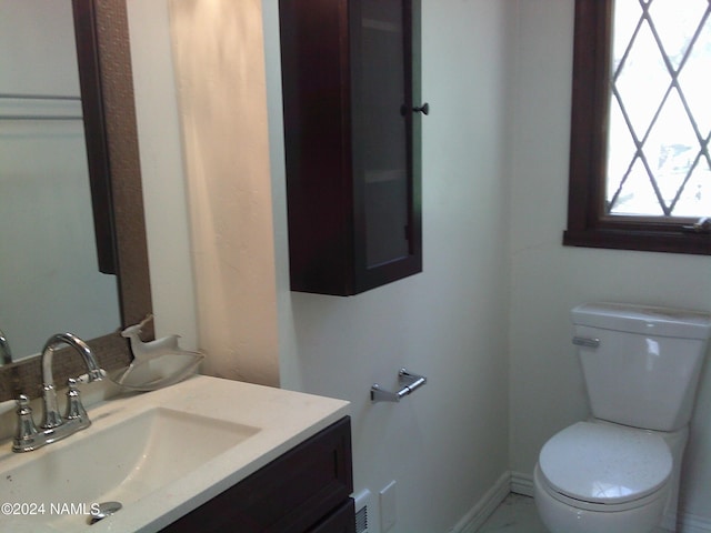 bathroom featuring toilet and vanity