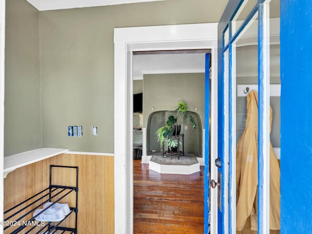 hall with hardwood / wood-style flooring and ornamental molding