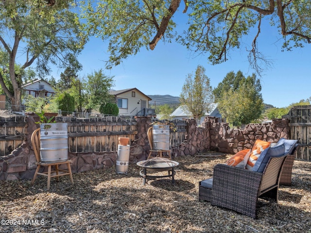 view of yard with a mountain view and a fire pit