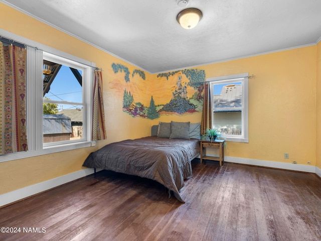 bedroom with crown molding, multiple windows, and dark hardwood / wood-style flooring