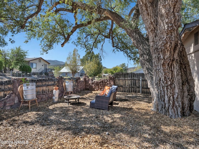 view of yard with an outdoor fire pit