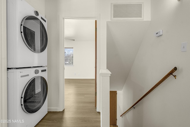 501 W Santa Fe Ave Unit 3, Flagstaff, AZ 86001 - laundry area with visible vents, wood finished floors, stacked washer / drying machine, baseboards, and laundry area
