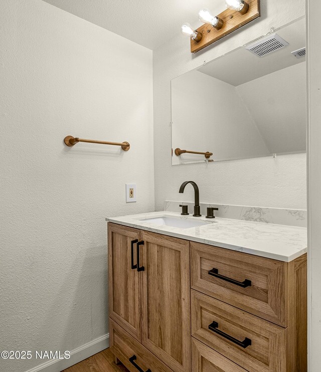 501 W Santa Fe Ave Unit 3, Flagstaff, AZ 86001 - bathroom featuring visible vents, vanity, a textured wall, and wood finished floors