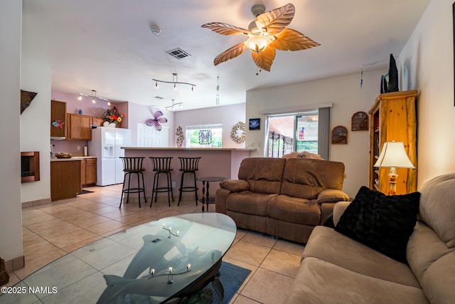 9129 W Arden Ln, Bellemont, AZ 86015 - living room featuring a ceiling fan, light tile patterned floors, and rail lighting
