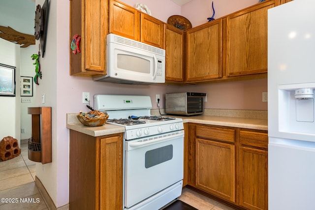 9129 W Arden Ln, Bellemont, AZ 86015 - kitchen with white appliances, light tile patterned floors, and light countertops
