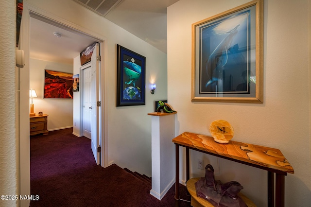 9129 W Arden Ln, Bellemont, AZ 86015 - corridor with dark carpet and baseboards