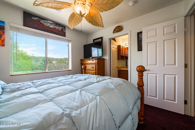 9129 W Arden Ln, Bellemont, AZ 86015 - bedroom featuring dark colored carpet, ceiling fan, and ensuite bathroom