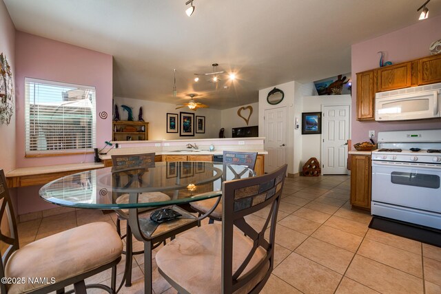 9129 W Arden Ln, Bellemont, AZ 86015 - dining space with light tile patterned floors, ceiling fan, and track lighting