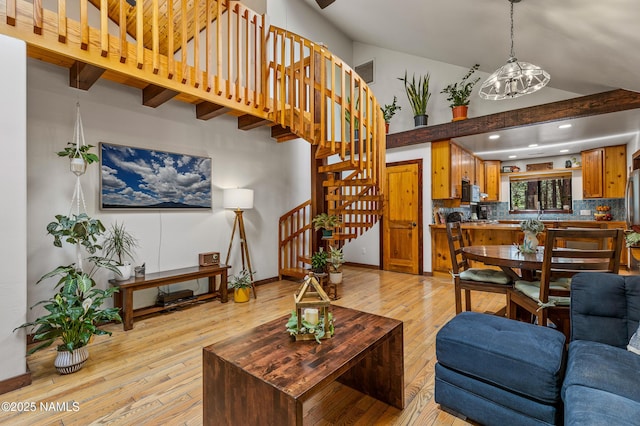 435 N Laramy Ln, Parks, AZ 86018 - living room with light wood-style flooring, stairway, recessed lighting, beam ceiling, and a towering ceiling