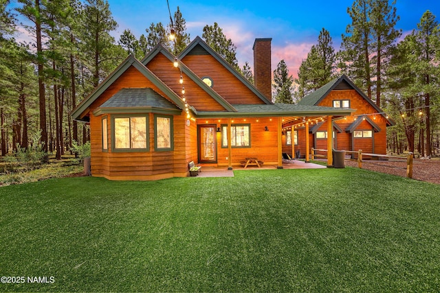 435 N Laramy Ln, Parks, AZ 86018 - back of house featuring a chimney and a yard