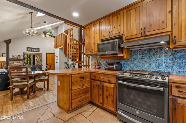 435 N Laramy Ln, Parks, AZ 86018 - kitchen featuring appliances with stainless steel finishes, under cabinet range hood, a peninsula, tasteful backsplash, and lofted ceiling