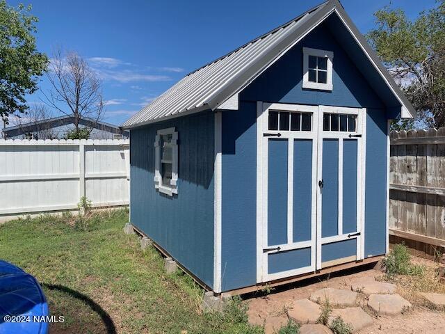 view of outbuilding featuring a lawn