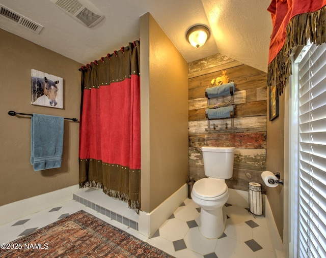 8134 Mclaws Ave, Joseph City, AZ 86032 - bathroom with wood walls, tile patterned floors, and toilet