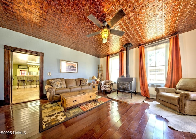 8134 Mclaws Ave, Joseph City, AZ 86032 - living area with an ornate ceiling, a wood stove, ceiling fan, and hardwood / wood-style flooring