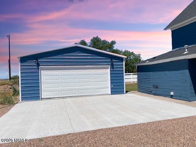 view of garage at dusk